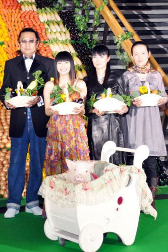 野菜で作った虹色のカーペットを背にした4人の登壇者と1匹の登壇豚