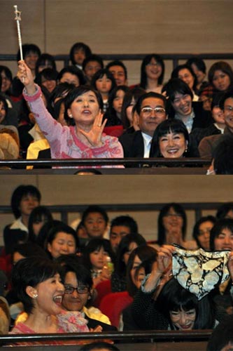 ［写真上］客席から松居棒を振りかざし声をかける松居一代（左）と幸夫人（右）
［写真下］涙を拭った大きなハンカチを客席から振り上げる幸夫人（右）と松居一代（左）。幸夫人は少々照れくさそう